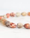 Necklace with multicolored beads on a white background