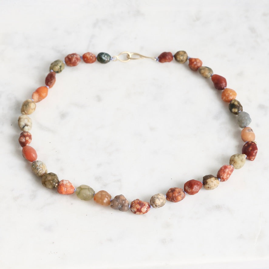 Necklace with multicolored beads on a white background