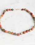 Necklace with multicolored beads on a white background