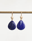 Bright blue lapis earrings with gold ear wires accented with a shell detail
