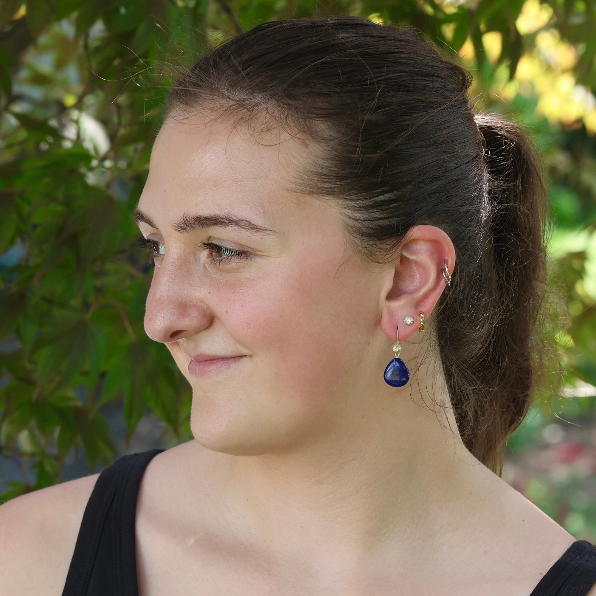 Woman wearing bright blue lapis earrings