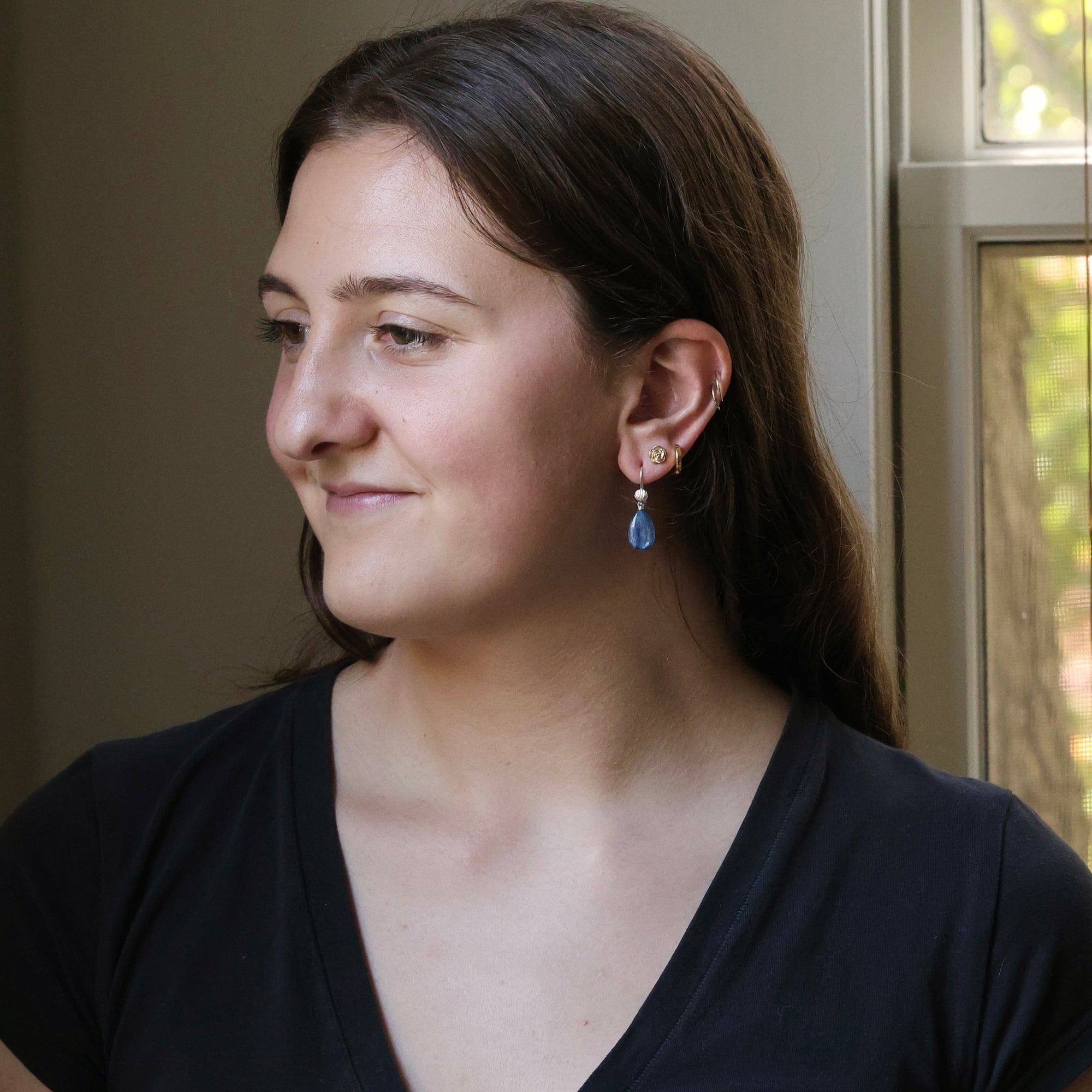 Woman wearing a black top with a neutral background