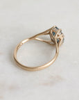 Gold ring with gemstone on a light marble background