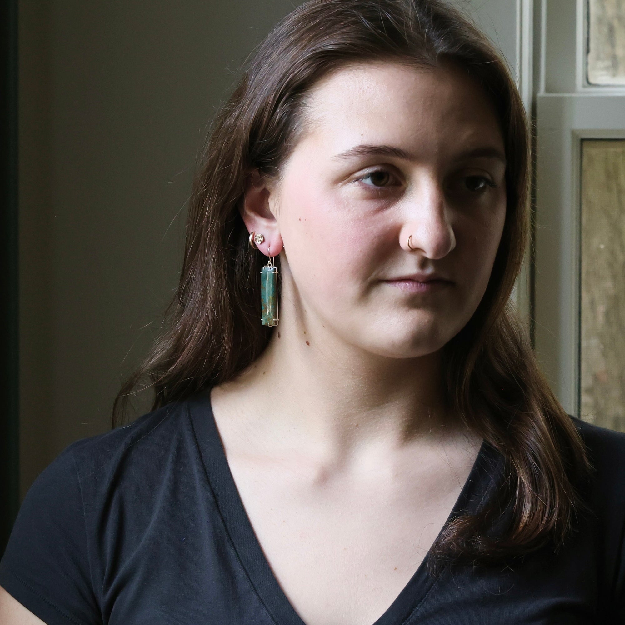 Woman wearing a black top with a neutral background