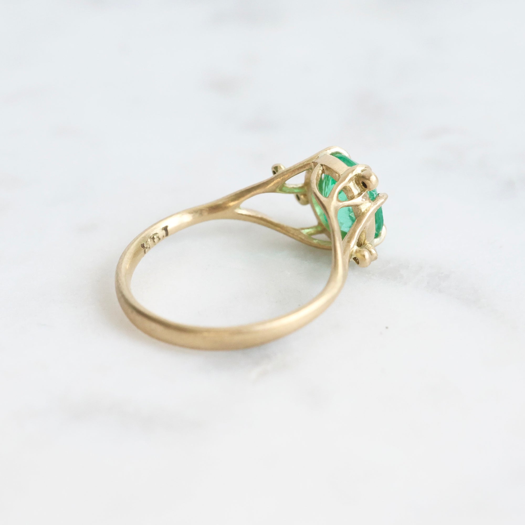 Bright green stone ring with diamonds and branchy prongs