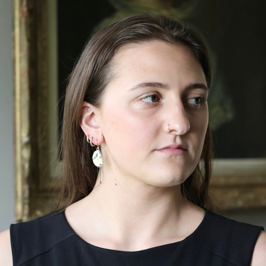 Woman wearing moss agate earrings