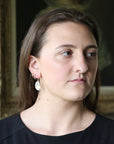 Woman wearing moss agate earrings
