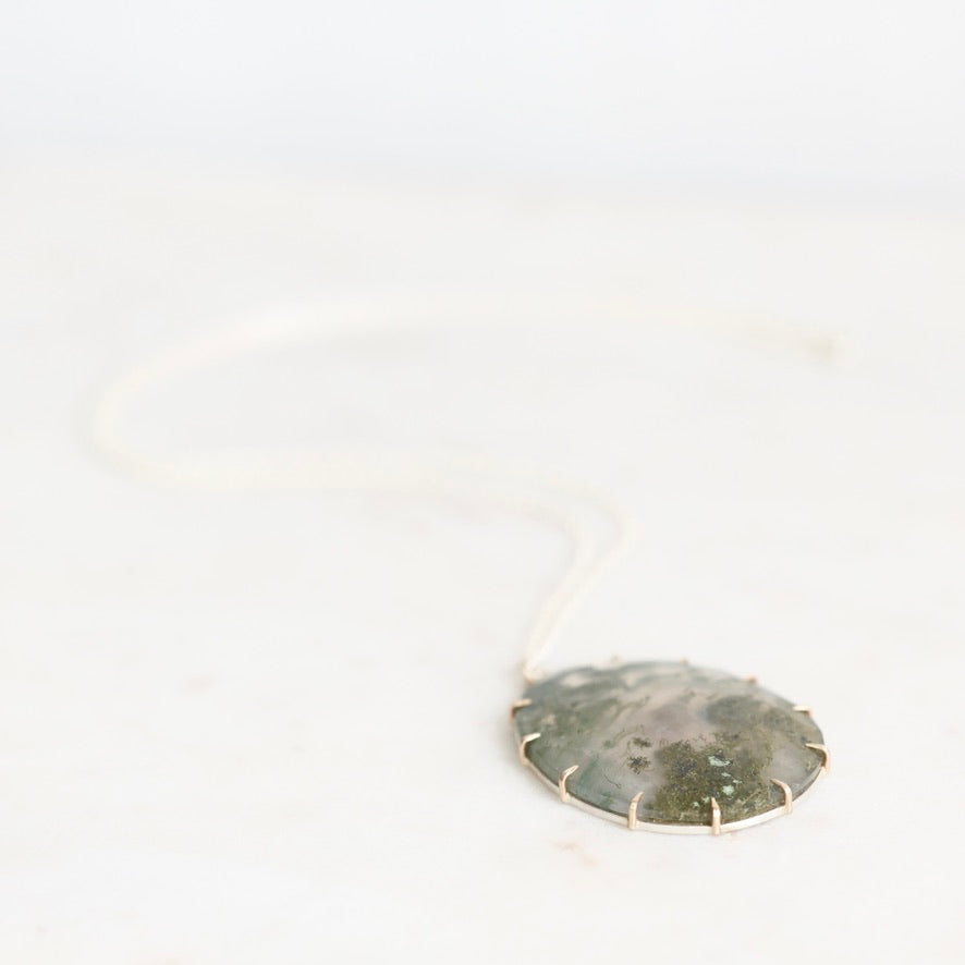 Moss agate pendant with gold prongs