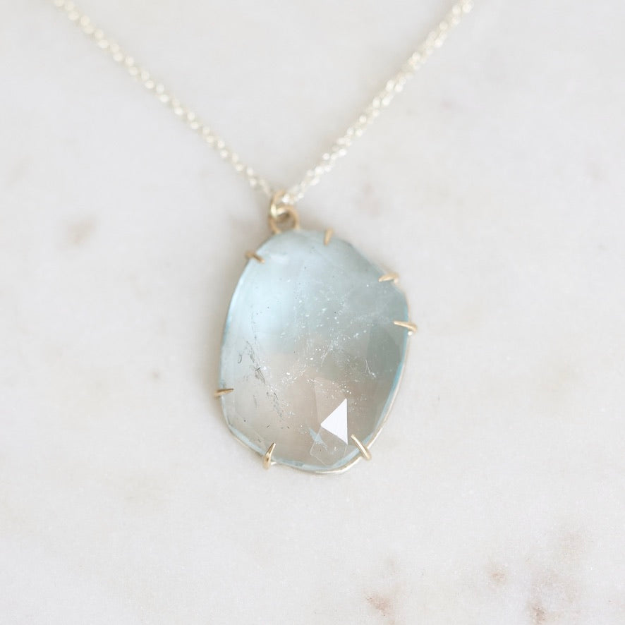Blue topaz necklace pendant with gold prongs