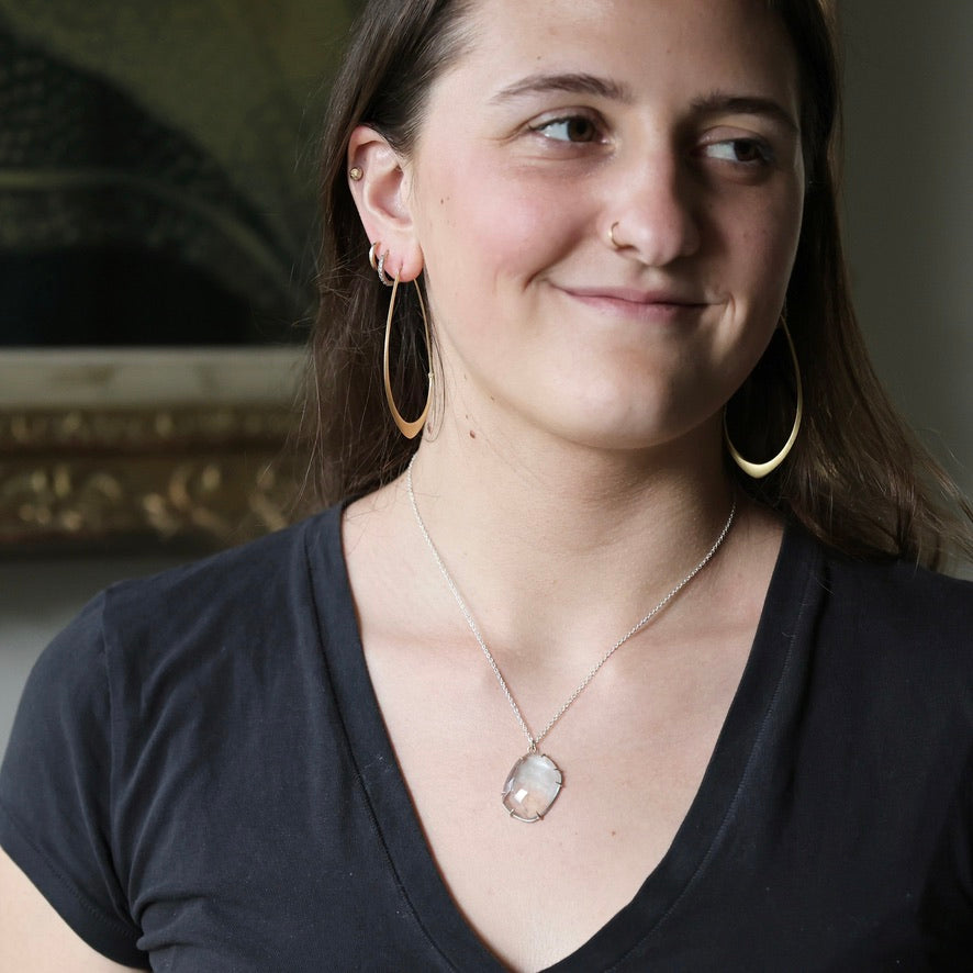 Woman wearing blue topaz necklace