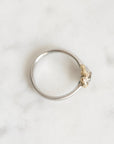 top down photo of platinum ring with gold barnacles 