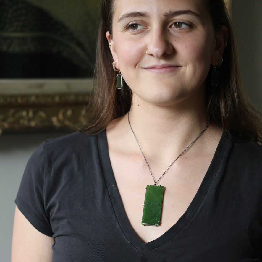 Woman wearing large stone pendant necklace