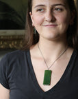 Woman wearing large stone pendant necklace