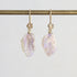Pale colored fossilized opals suspended from gold ear wires with rose detailing. 