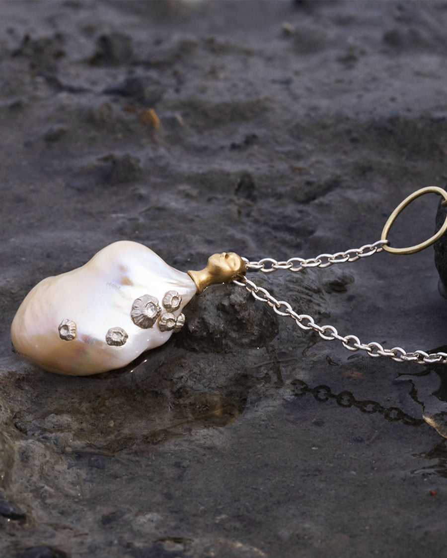 Hannah Blount pearl pendant necklace with silver barnacles and topped with her gold cameo grey lady head. 