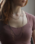 several oxidized silver and 14k gold egg link necklaces on person- Hannah Blount