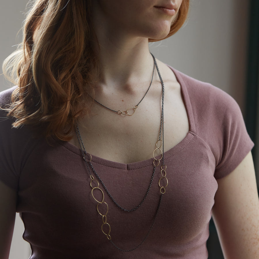 several oxidized silver and 14k gold egg link necklaces on person- Hannah Blount