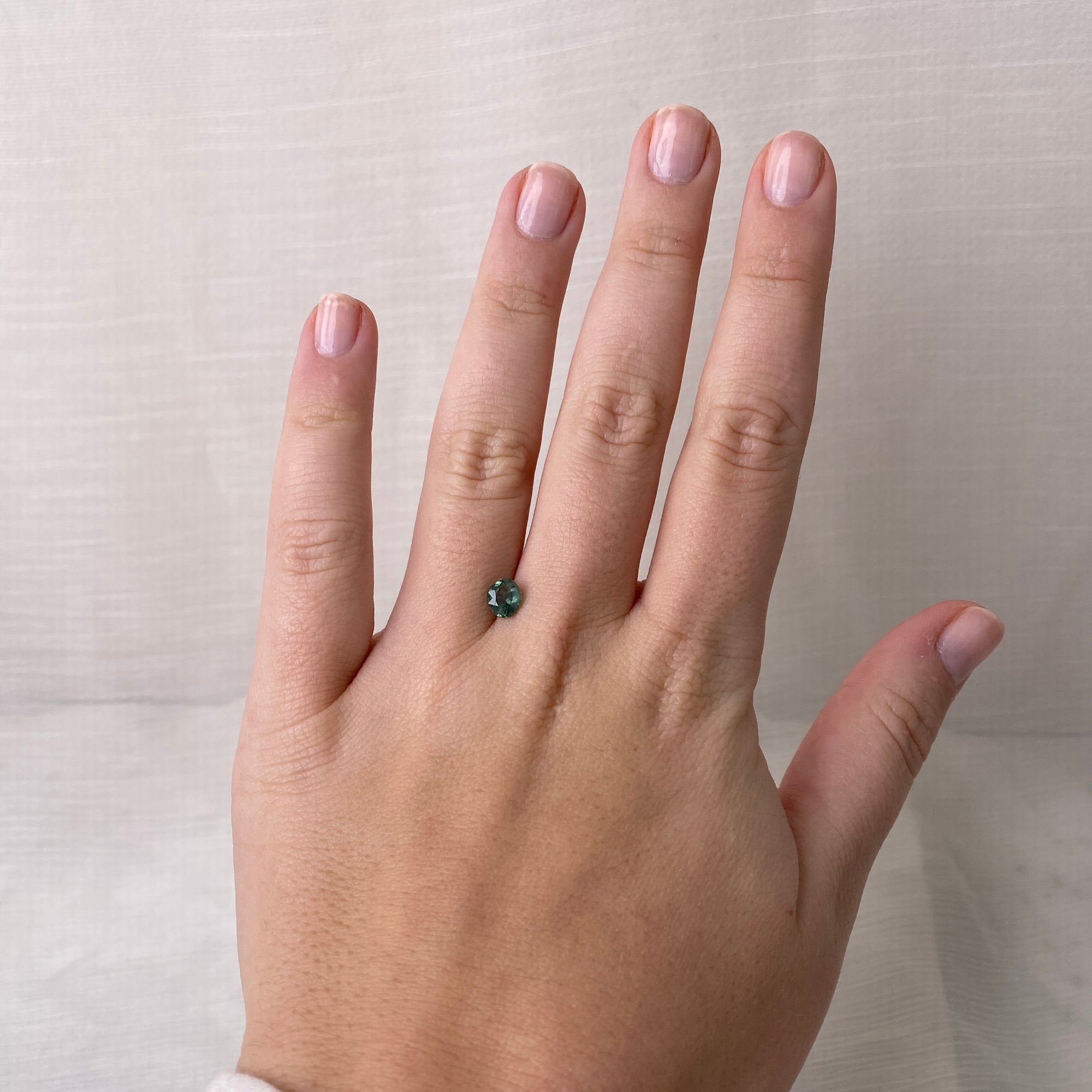blue/green stone on hand 